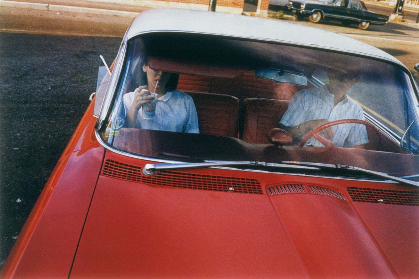 William Eggleston, Untitled (couple in red car at drive-in restaurant),